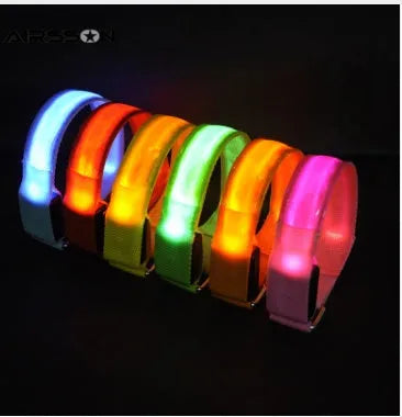 Illuminated arm band with LED lights on a black ribbon, adjustable, showing blue and red colours