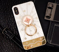 Rose gold and white diamond ring phone stands attached to iPhones, showing grip and kickstand functions.