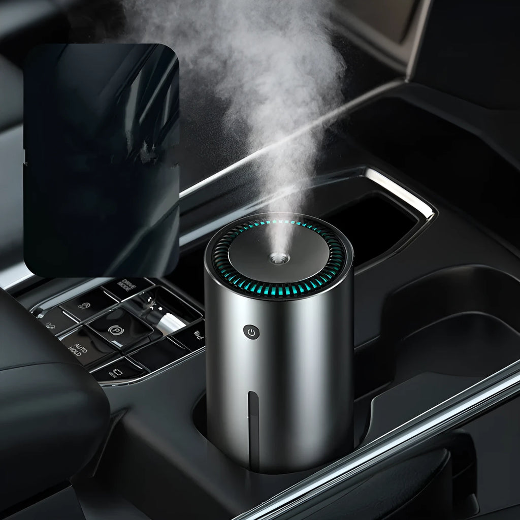 Black aluminium alloy car diffuser humidifier with USB cable on a car dashboard.