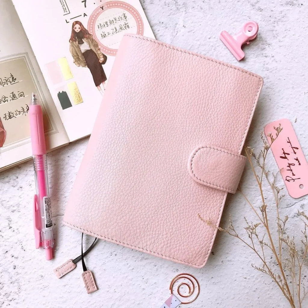 A6 leather notebook with lychee pattern cowhide cover showing loose-leaf binding in three colour options