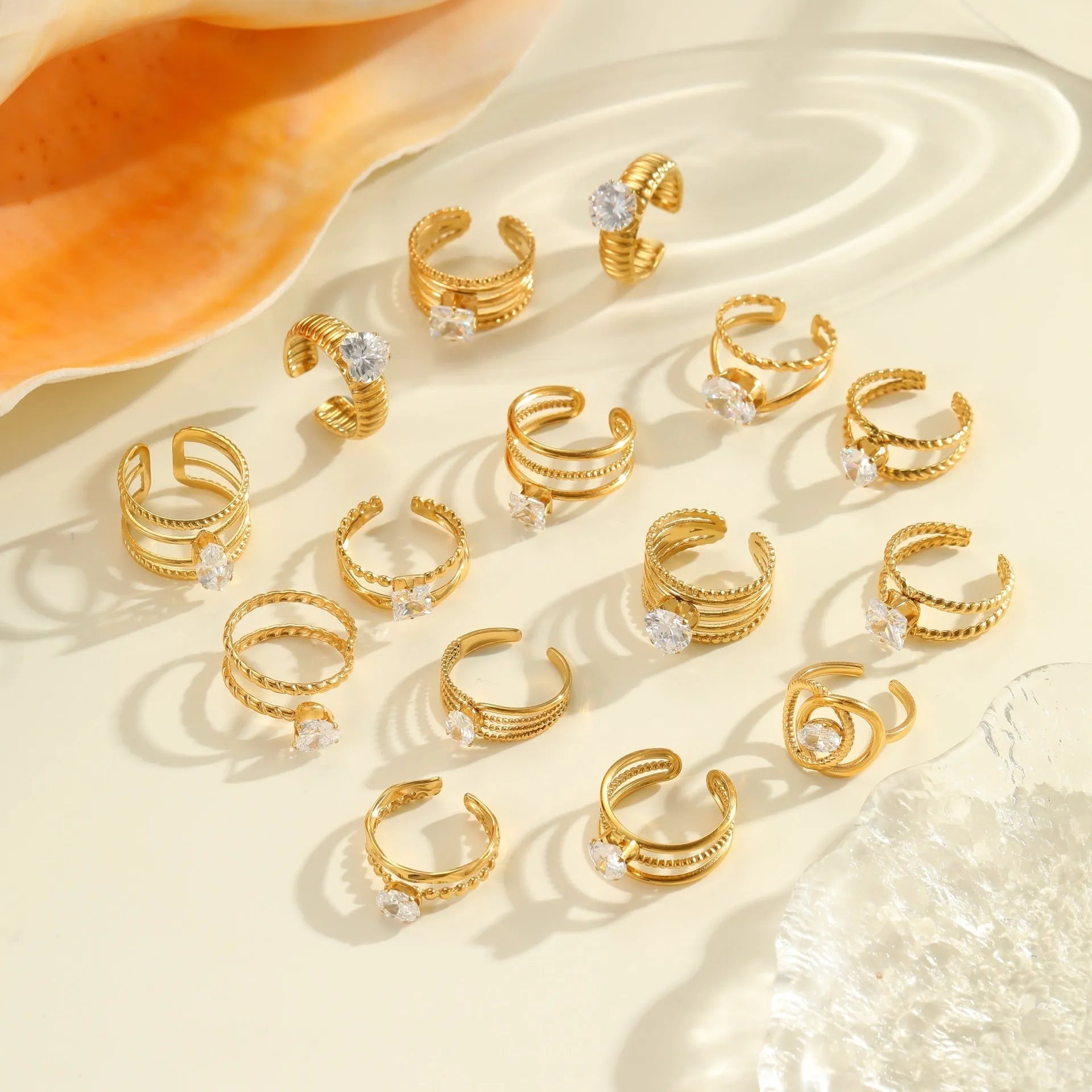 Gold colour stainless steel ring with zircon stones in a geometric heart drop shape design, open mouth.