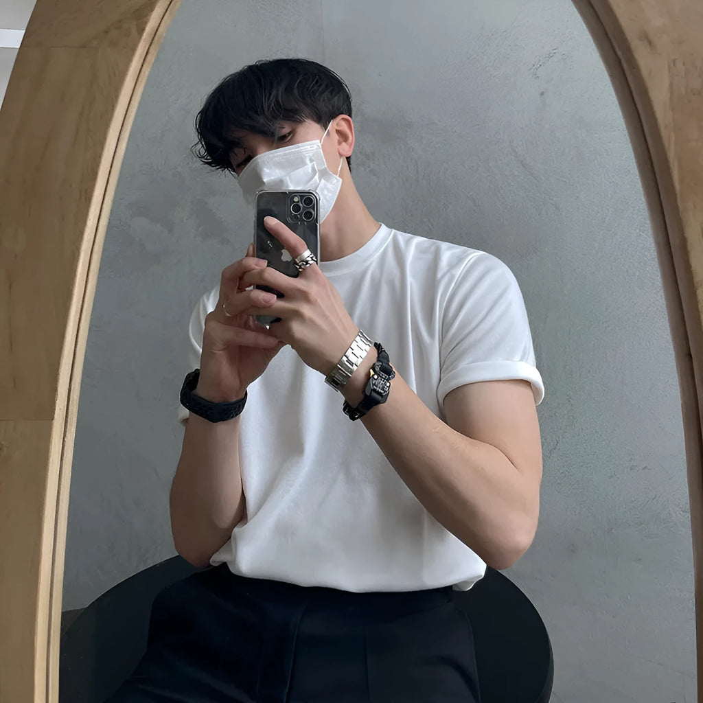 Men's slim fit cotton t-shirt in black on a hanger, showing round neck and short sleeve.