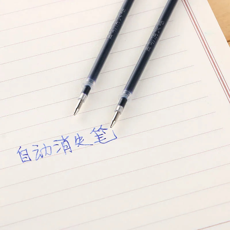Automatic fade and disappear pen set showing pen holder, case, and eight refills on a notepad.