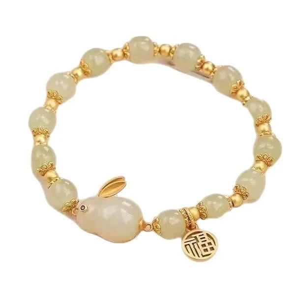 Green electroplated jade hare bracelet for women with Chinese style and lily design elements.