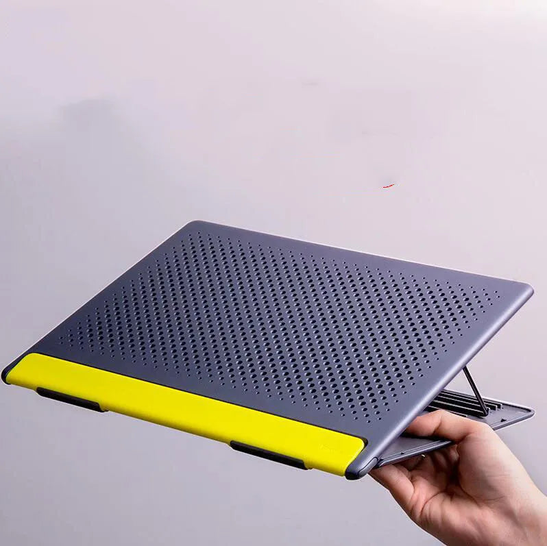 Portable black aluminium notebook stand folded flat next to a laptop
