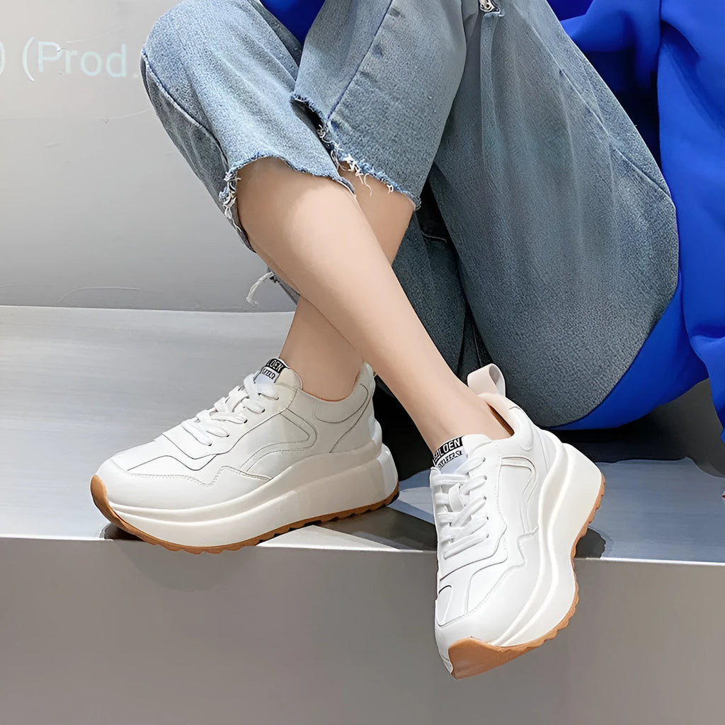 Women's beige low-top casual leather sports shoes with lace-up front and cross-strap detail on a white background