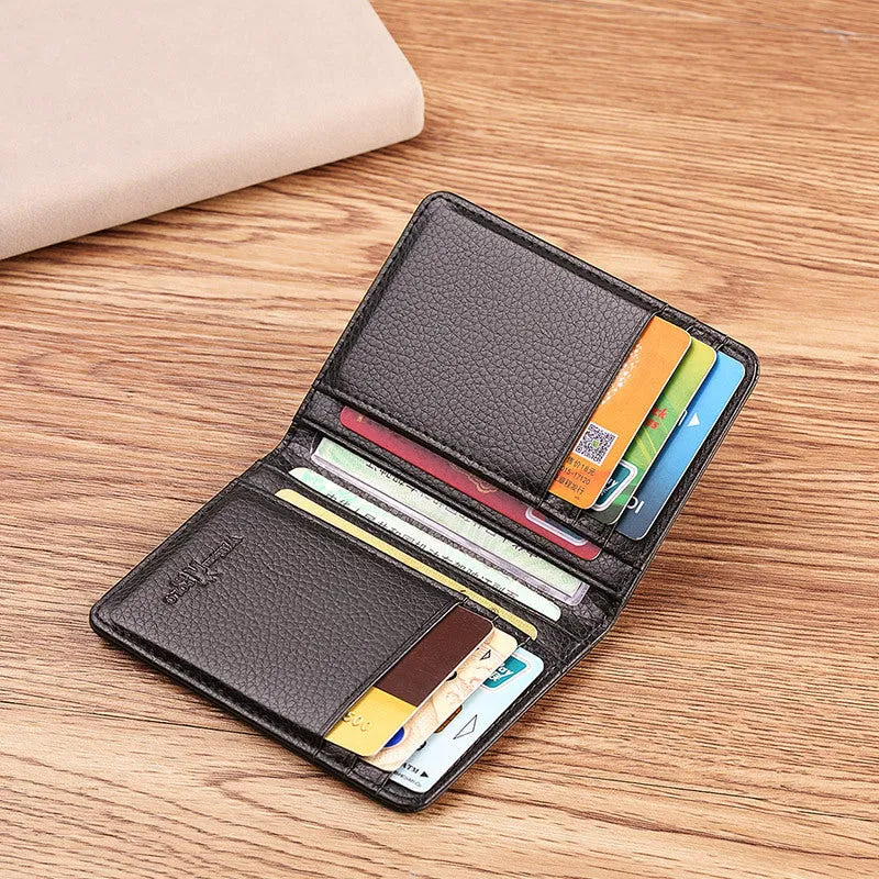 Ultra-thin cowhide leather card ID wallet in solid colour black on flat surface