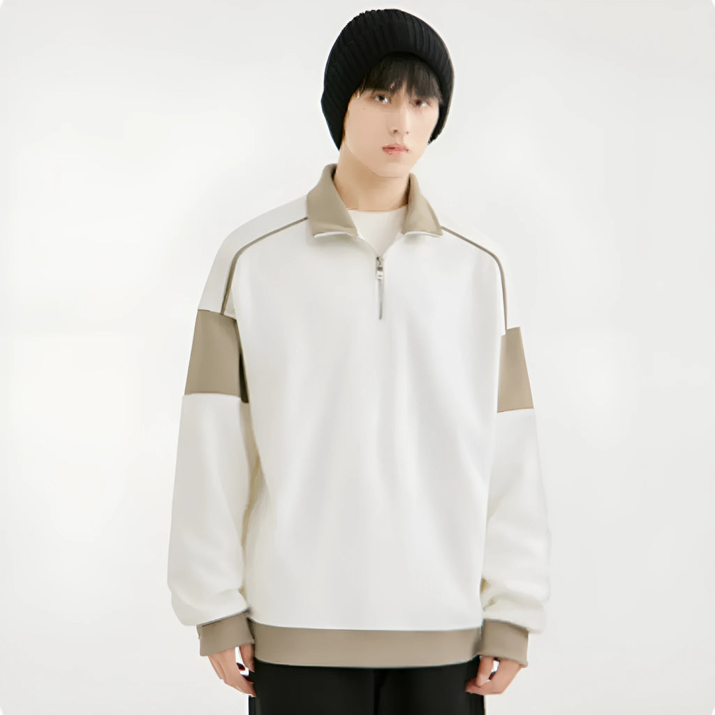 Man wearing a grey corduroy hooded sweater with drop shoulders and loose lapels