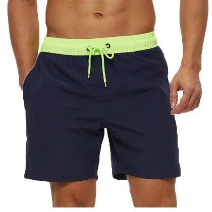 Men's blue drawstring athletic shorts with a zip pocket and stitching detail on the waistband.