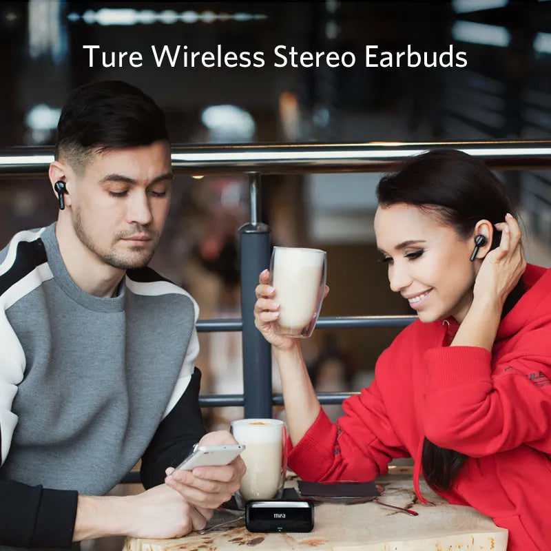 Black and white true wireless earbuds with charging case on a table, showing compact design.