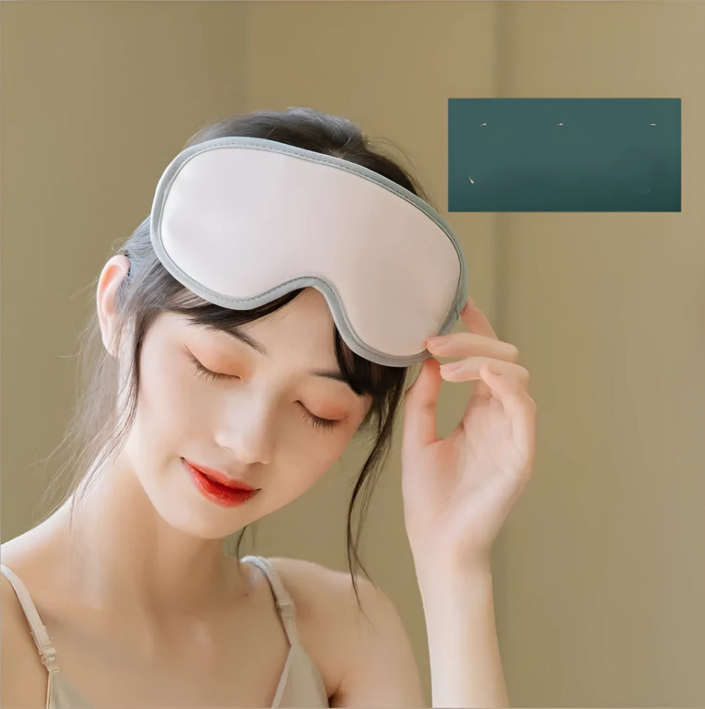 Pink portable eye SPA mask with steam and vibration massage functions on a grey background.
