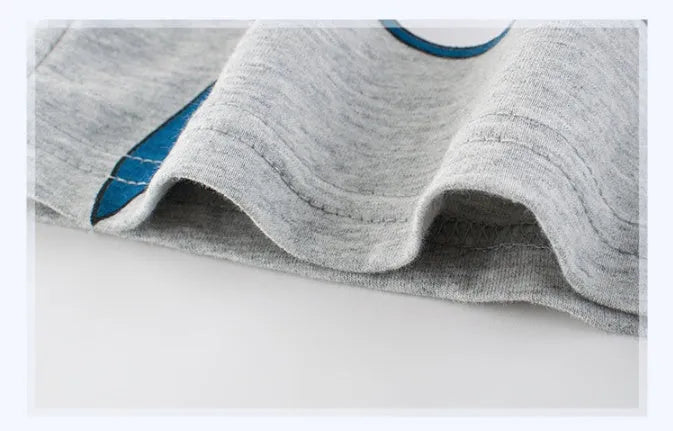 Grey cotton children's t-shirt laid flat, showing Asian size tags for 90cm, 100cm, 110cm, 120cm, 130cm, and 140cm lengths.