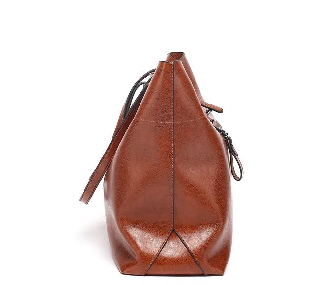 Brown waxed cowhide cross-body leather handbag showing front view with strap, measuring 30cm wide by 37cm tall.
