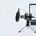 Black condenser microphone on aluminium stand with 3.5mm and USB cables for mobile and computer broadcasting