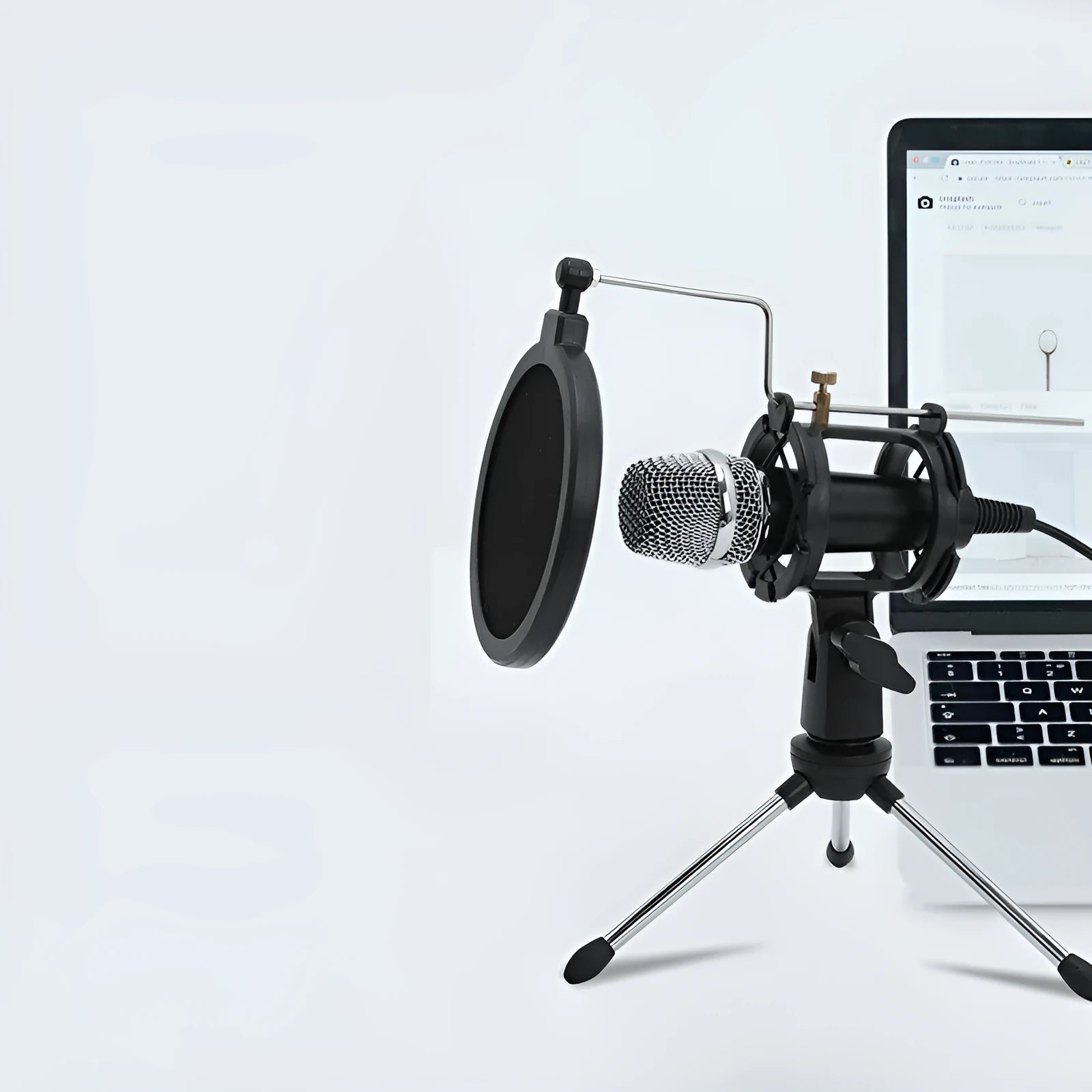 Black condenser microphone on aluminium stand with 3.5mm and USB cables for mobile and computer broadcasting