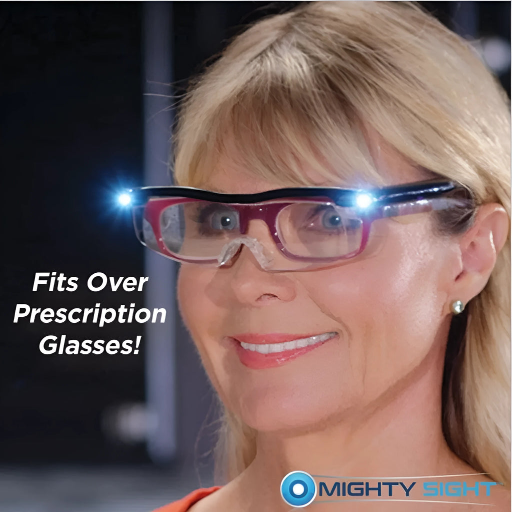 Transparent black USB LED light reading glasses on a table, showing the integrated light and frame.