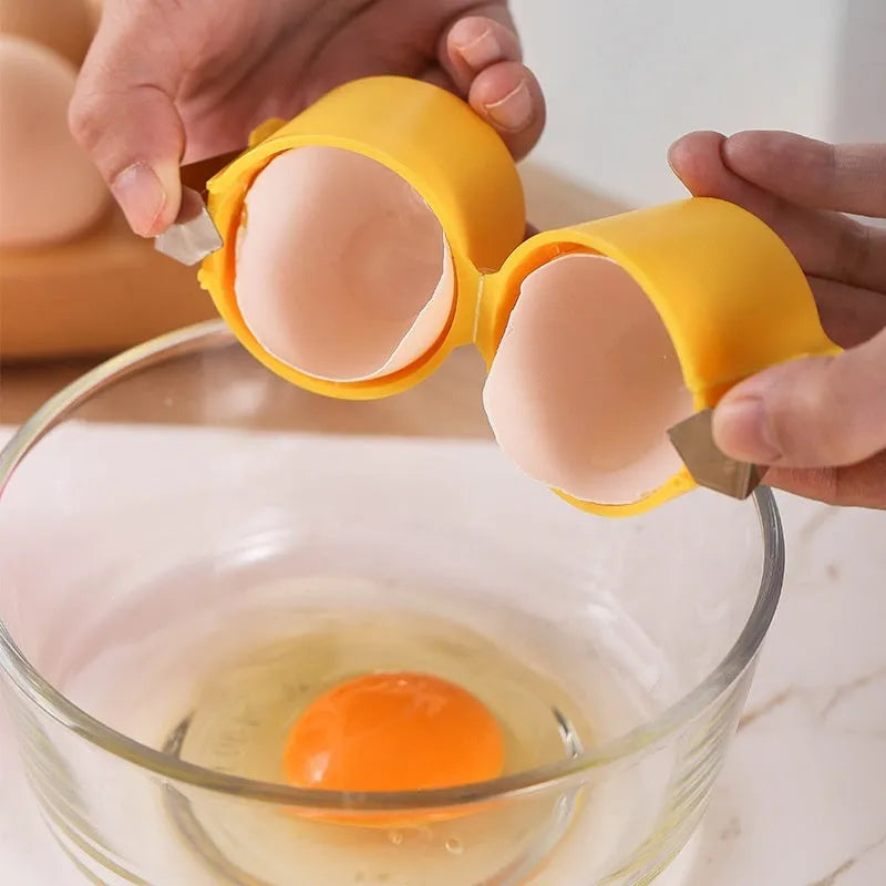Egg shell opener and beater kitchen tool in pink, yellow, or orange colour on a kitchen counter.