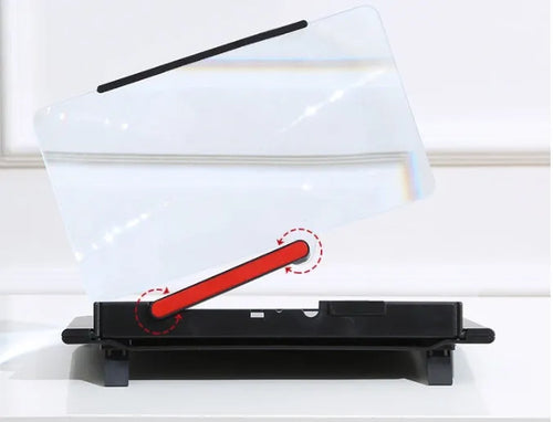 Black 12-inch mobile phone screen amplifier with pull-out stand on a table next to a phone.