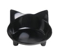 Shallow black melamine cat bowl with non-slip rubber base on a kitchen counter.
