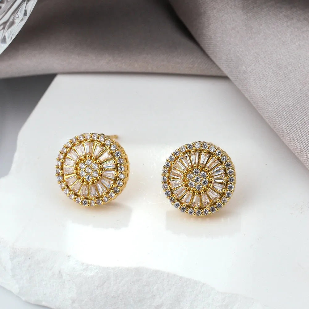 A pair of INS-style geometric earrings with a round pattern design in electroplated E160 gold colour.