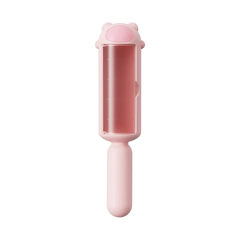Blue pet hair remover tool with a self-cleaning base on a fabric sofa.