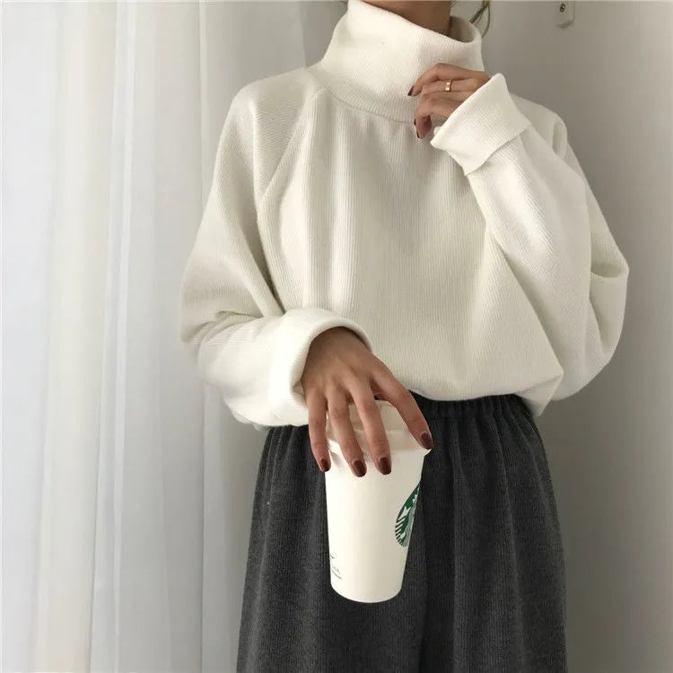 Women's loose fit solid colour long sleeve top with a half-high collar in apricot, on a size chart background.