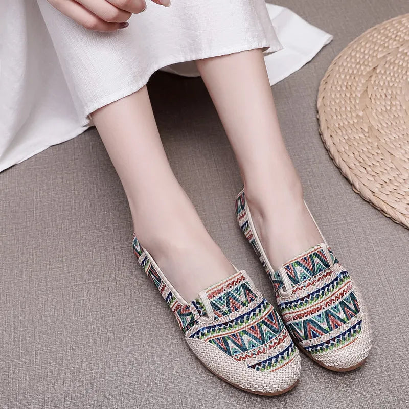 Women's ethnic style flat cloth shoes in red with colour stitching and a beef tendon sole.