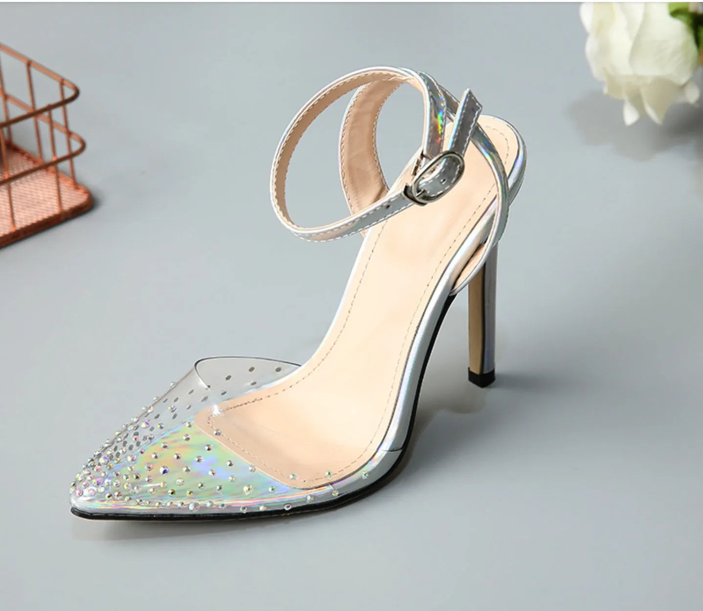 Women's pointed toe stiletto sandals with crystal diamond decoration on a PVC upper.