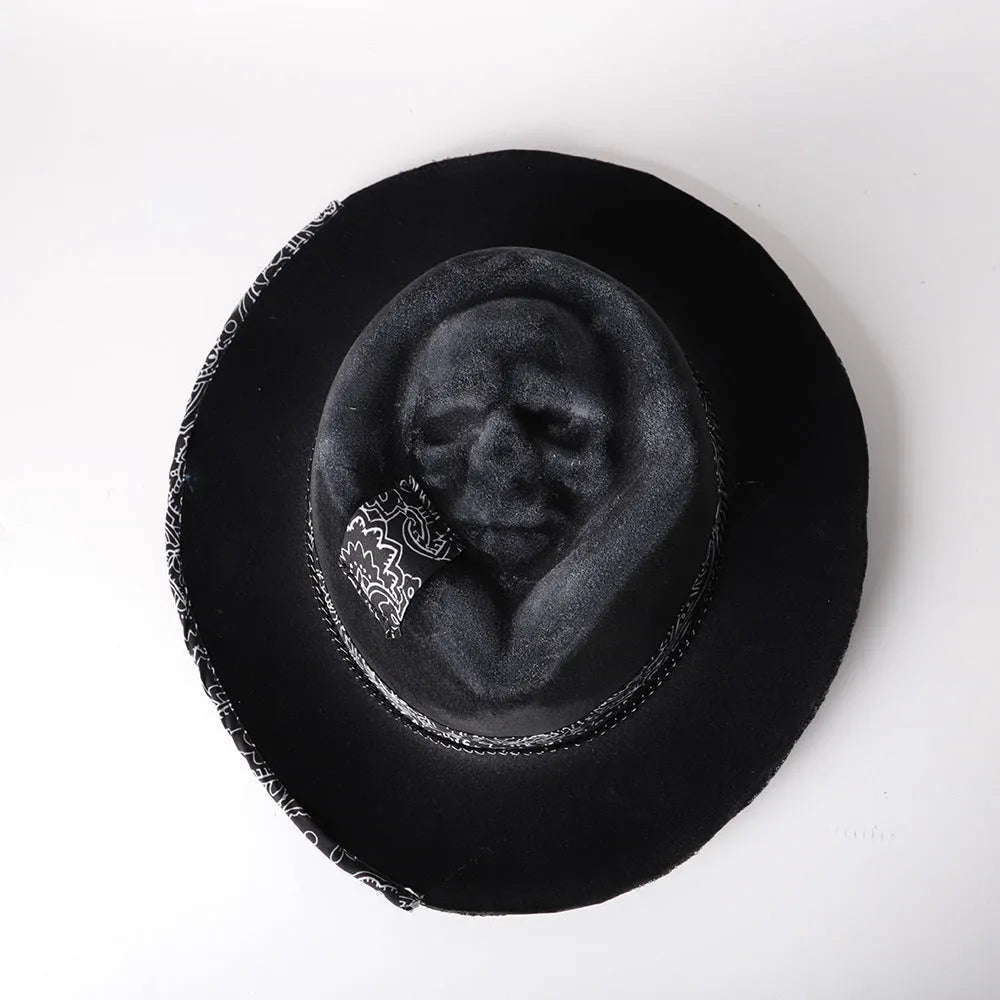 Handmade conical skull hat in wool felt and denim, shown from the side, highlighting its structured crown shape.