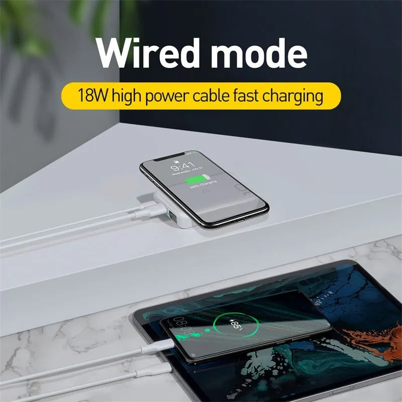 Small square black portable power bank with LED digital display on a table.