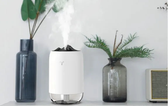 Mini cylindrical USB humidifier in turquoise green with water tank and mist outlet