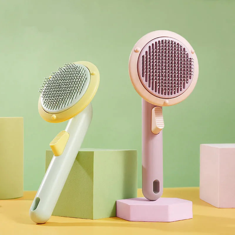 Pumpkin-coloured self-cleaning pet grooming brush with stainless steel needles for cats and dogs.