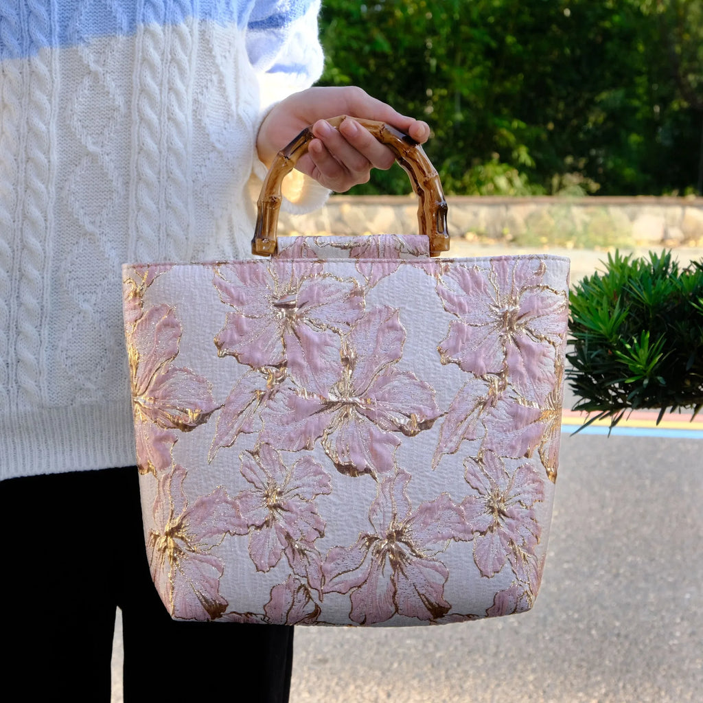 Light blue canvas shoulder bag with gold floral pattern showing 30x30x10 cm dimensions and double straps