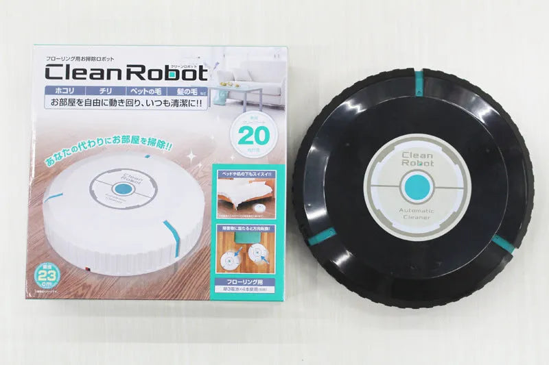 Black and white automatic robot vacuum cleaner on a wooden floor.
