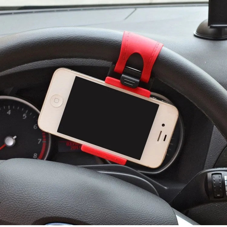 Black universal steering wheel phone clip holder with silicone pad mounted on a car steering wheel.