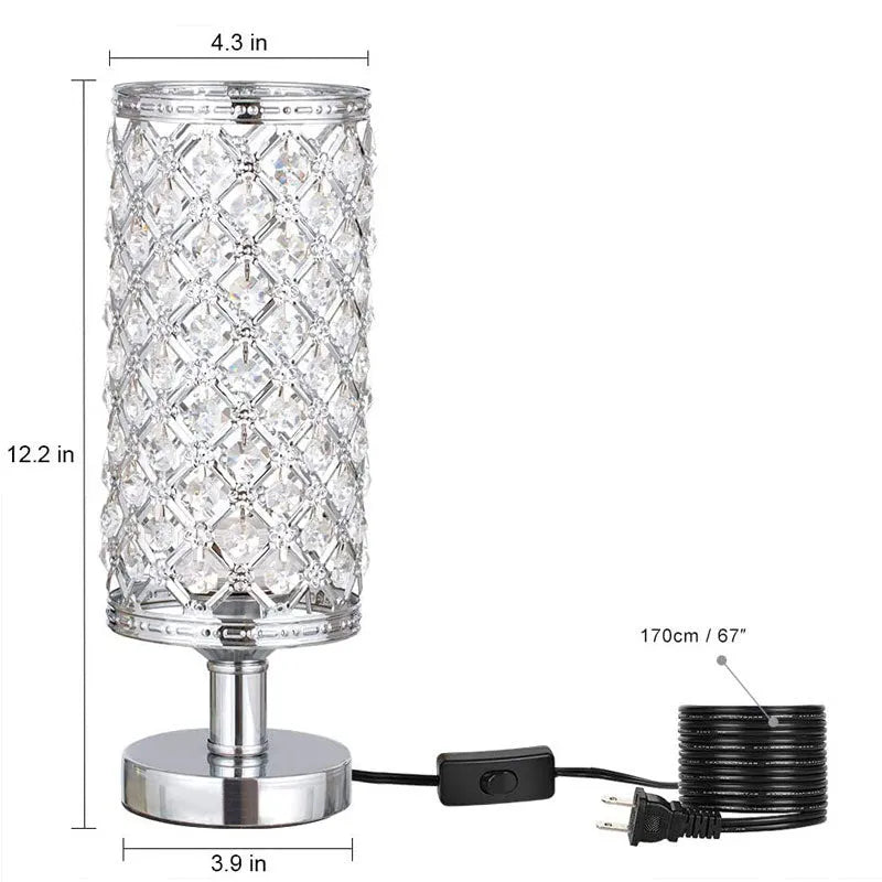 Modern crystal table lamp with gold metal base and hollow-carved crystal shade on a bedside table
