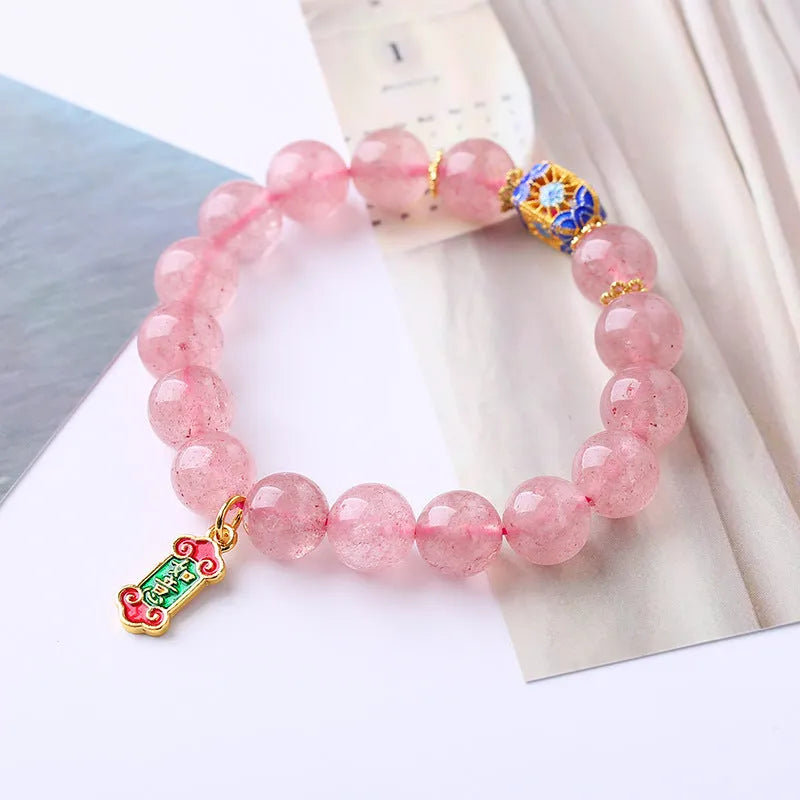 Pink strawberry quartz crystal bracelet with hand-woven Ruyi symbols and text elements