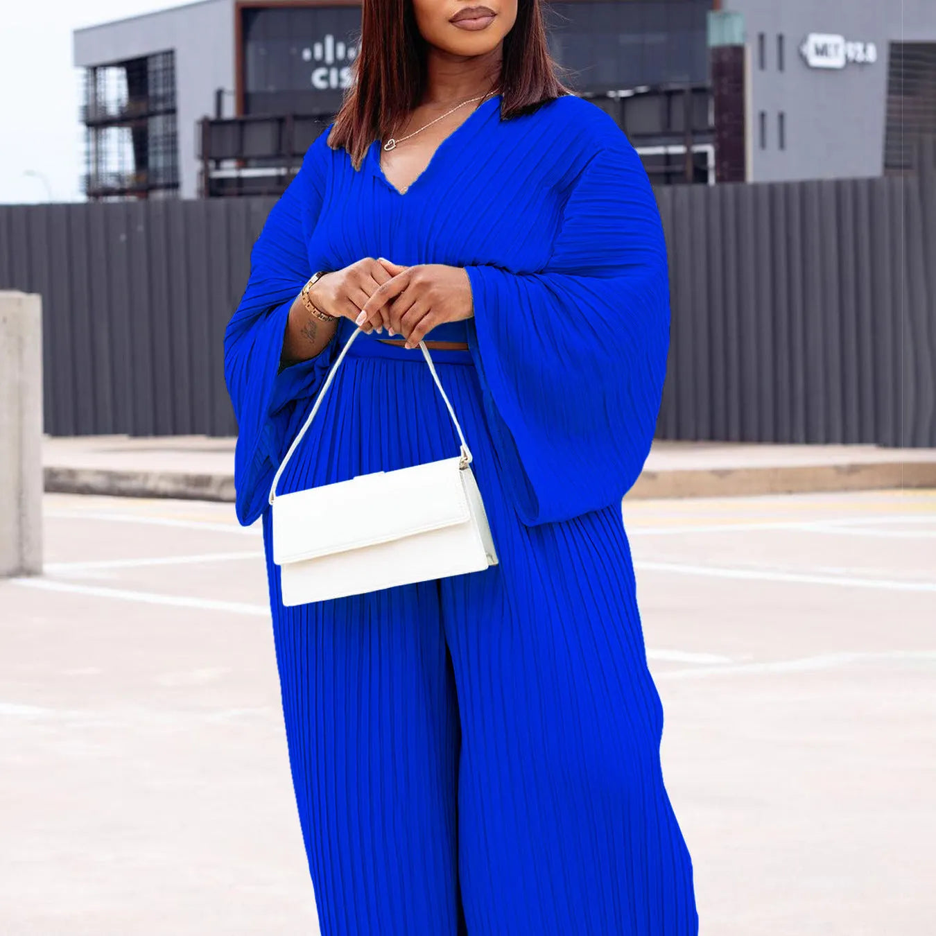 African suit two-piece set with batwing sleeve top and wide leg trousers in red or blue.
