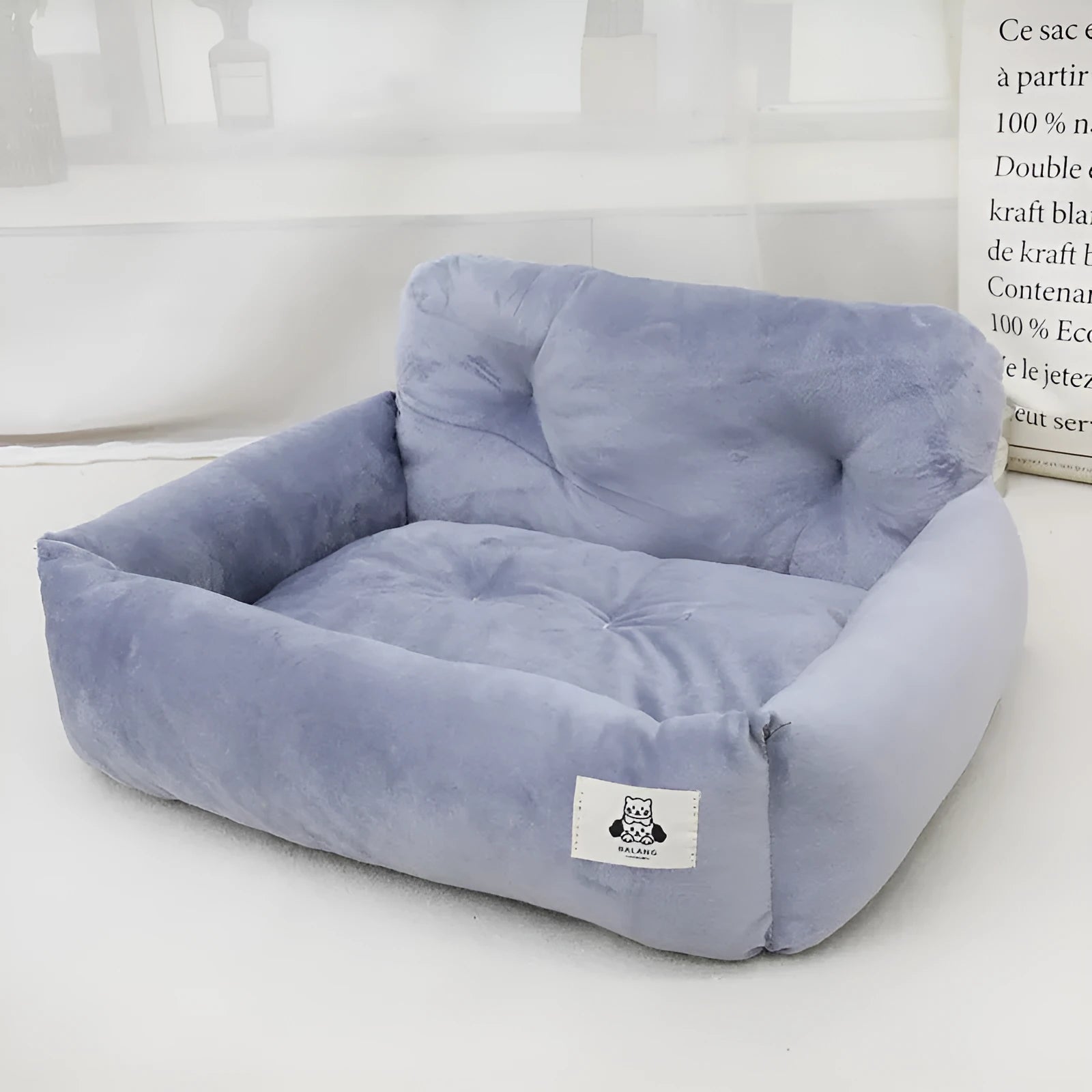 Grey and blue plaid cloth car-mounted dog travel nest shown in two size options.