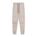 Men's grey loose-fit fitness trousers with ankle ties, made from quick-drying polyester fabric.