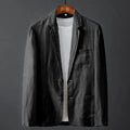 Men's solid colour slim fit linen suit jacket with nine-point sleeves on a hanger.