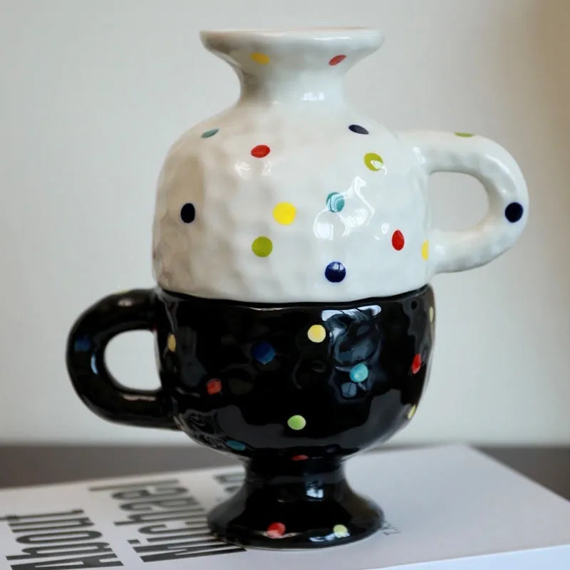 Hand-pinched irregular shaped solid colour ceramic mug on a table.