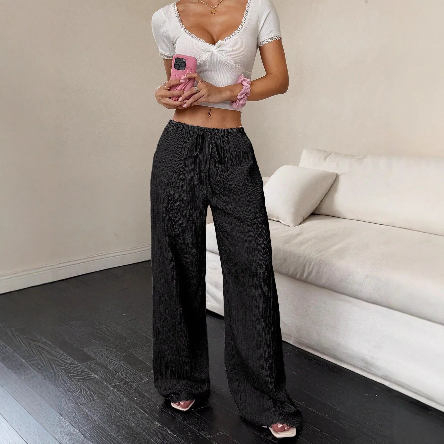 Women's black wide-leg trousers with a front lace-up waist detail on a mid-rise waistband.