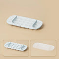 High-capacity ice cube tray ice box grid in blue with an ice shovel stored in its slot.