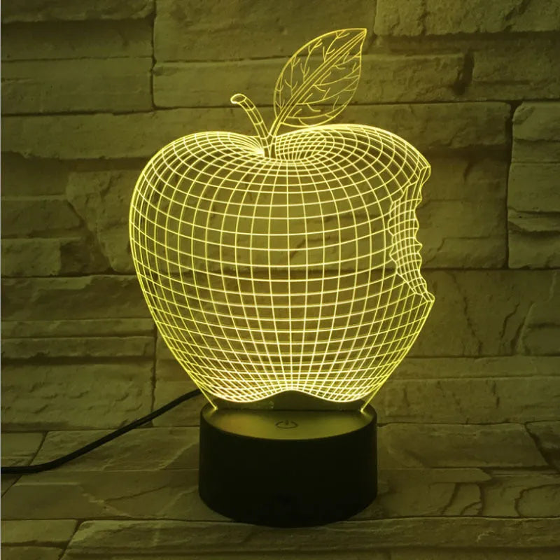 Colour-changing fruit-shaped acrylic night light with touch control on a surface.