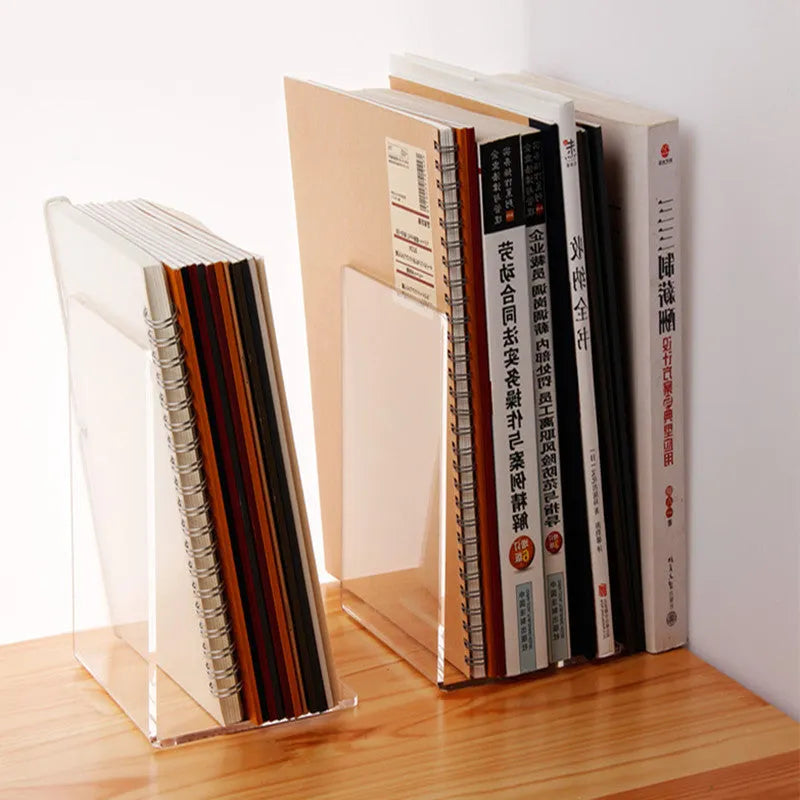 Transparent acrylic bookshelf display rack on a desk holding two books.
