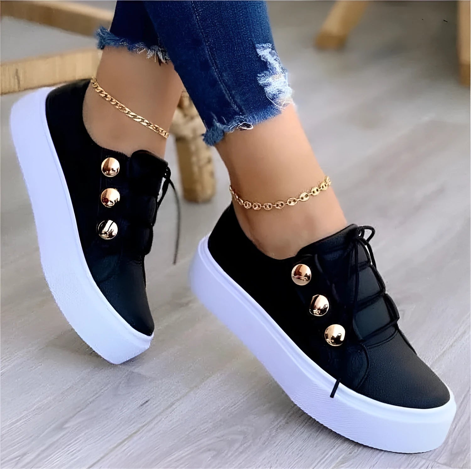 Women's white lace-up flats sneakers with round toe and silver rivet details on the upper.