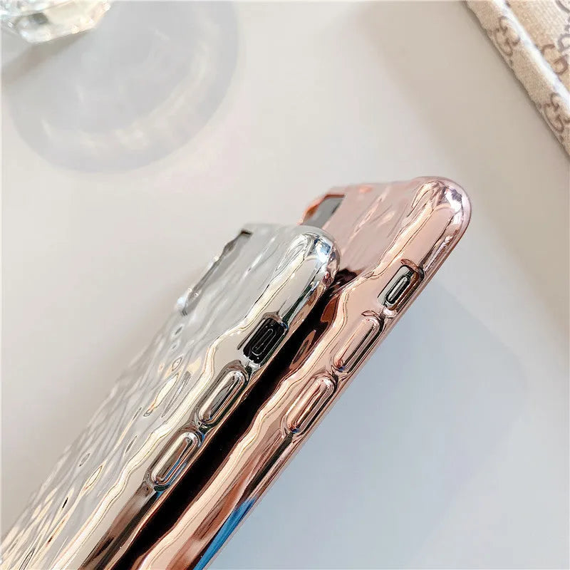 Rose gold and silver coloured TPU back cover cases for iPhone on a plain background.