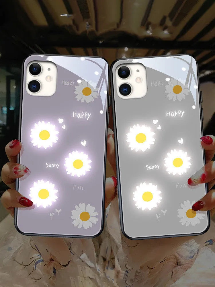 White iPhone case with painted daisies and a voice-activated coloured light strip on the back.