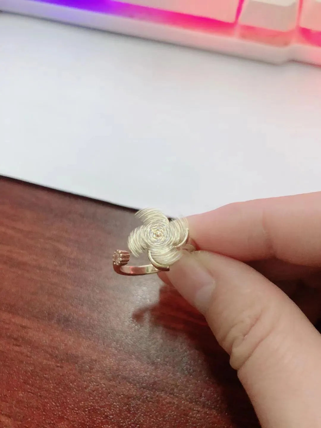 Gold and silver rotating windmill rings showing the spinning geometric copper design.